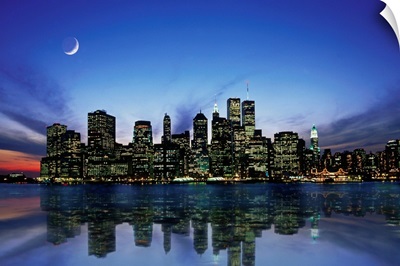 Manhattan skyline at night, reflecting in river