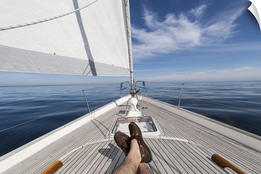 Man's feet crossed on 62 ft sailboat
