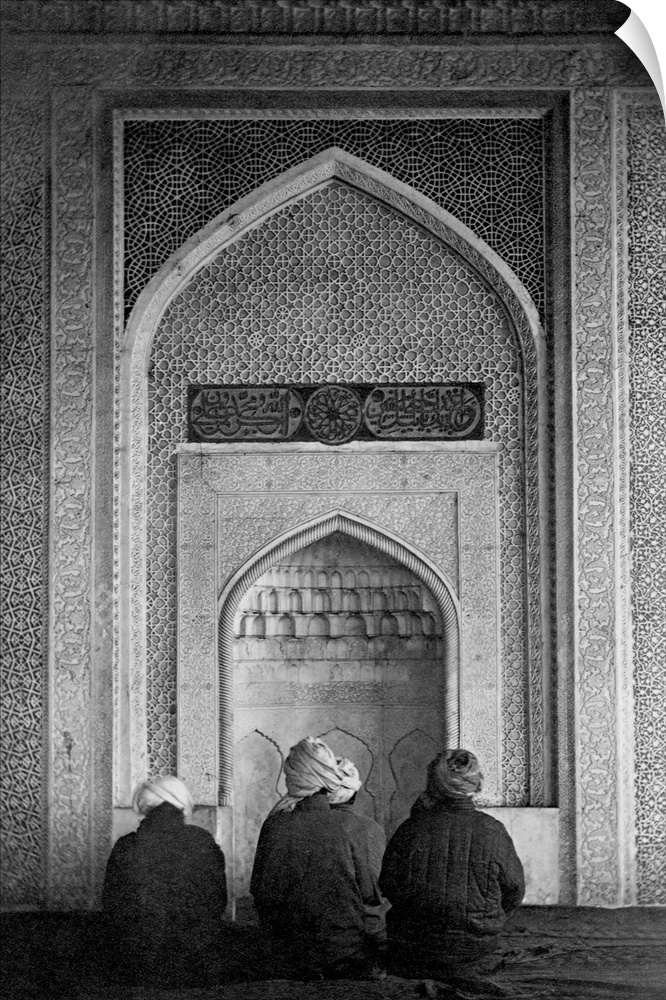Four Muslims pray at the qibla niche, a recessed part of a mosque wall which shows the direction of Mecca, at the Kok Gumb...