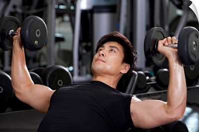 Mid-Adult Man Lifting Weights