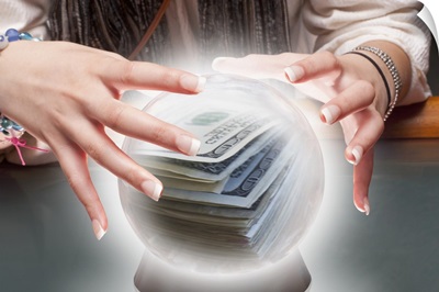 Mixed race fortune teller with crystal ball with money inside