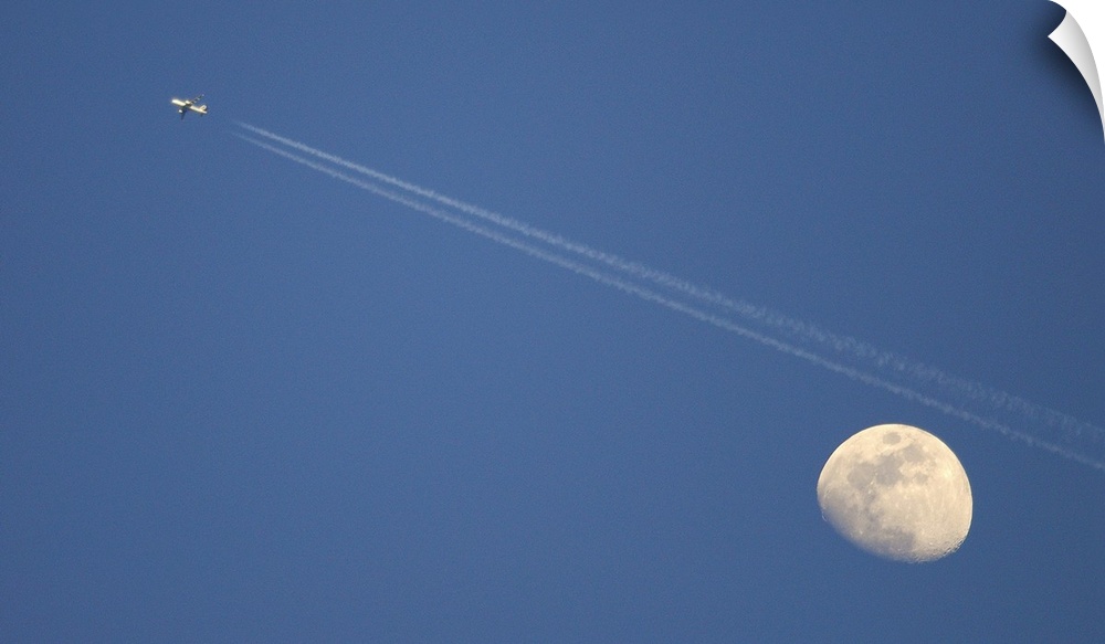 Moon and airplane in sky.