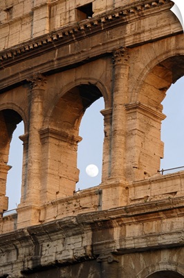 Moon framed by the arches of the Colosseum in Rome, Italy