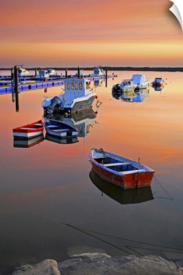 Moored boats on sea at sunset.