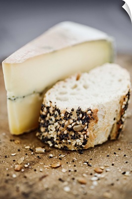 Morbier cheese on a board with seeded bread