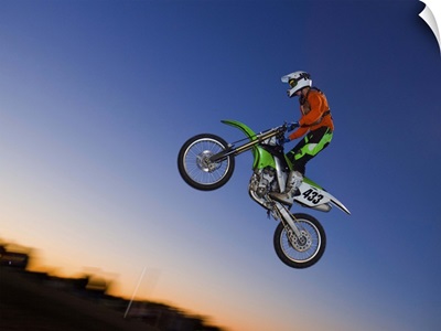 Motorcross rider jumping dirt bike