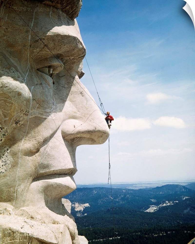 Tourists Never See Mount Rushmore from the Top. Looking more like a pesky fly than a repairman, Mike O'Mera check's Lincol...