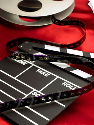 Movie clapboard and film reel