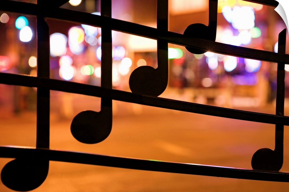 This is a landscape photograph with a shallow depth of field showing decorations and out of focus neon city lights.
