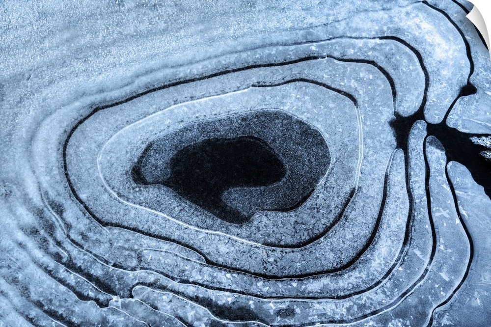 Naturally formed circular patterns in pond ice.