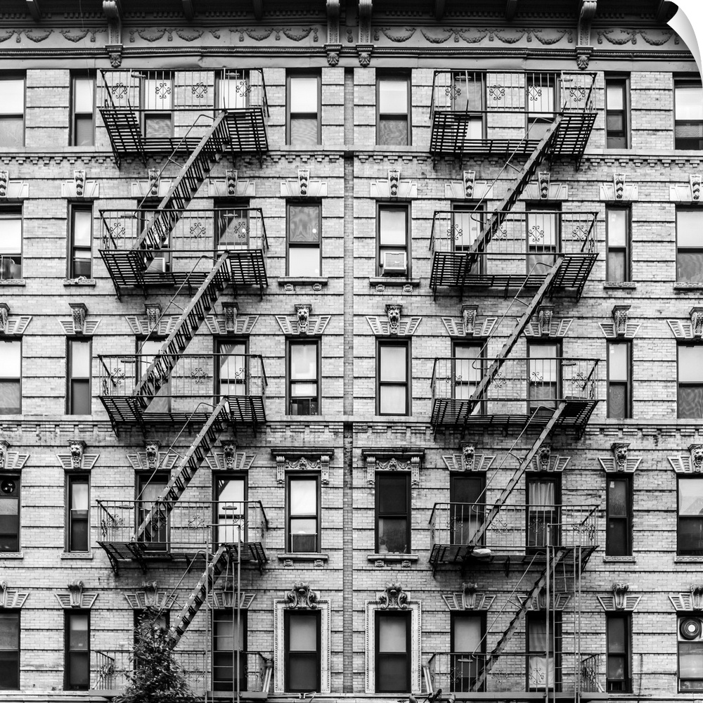 A fire escape of an apartment building in New York city. Graphic black and white image.