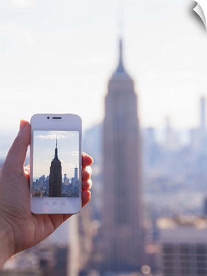 New York State, New York City, Manhattan, Tourist taking photo of Empire State Building
