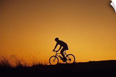Off-road biker at sunset, Discovery Park, Seattle, Washington, USA