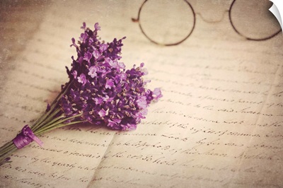 Old handwritten letter, pair of old fashioned round horn rimmed glasses and lavender.