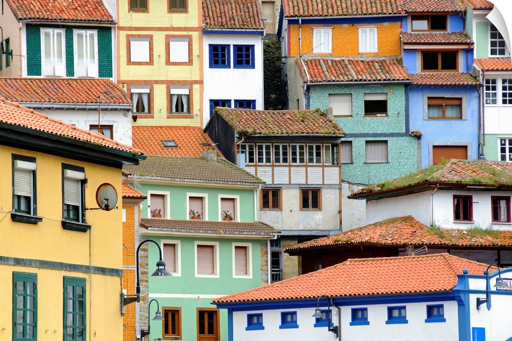This picture was taken of houses that are all different colors and shapes and are stacked behind each other in a city in S...