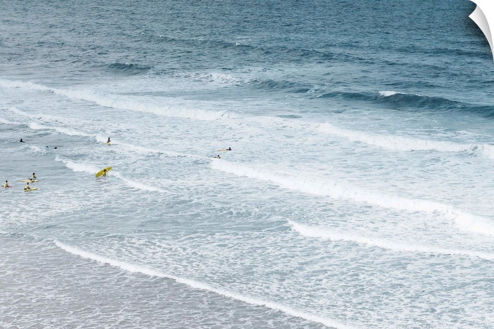 People learning to surf in atlantic ocean.