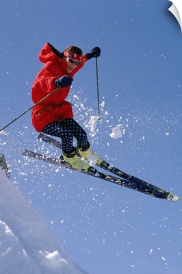 Person downhill skiing in mid air