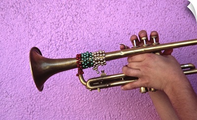Person playing trumpet, close-up of hands