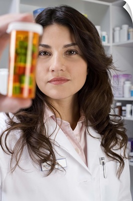 Pharmacist holding a pill bottle
