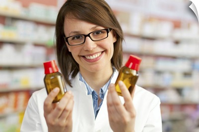 Pharmacist holding bottles of medication