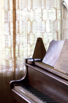 Piano with metronome and sheet music