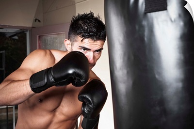 Portrait of young man boxing in gym