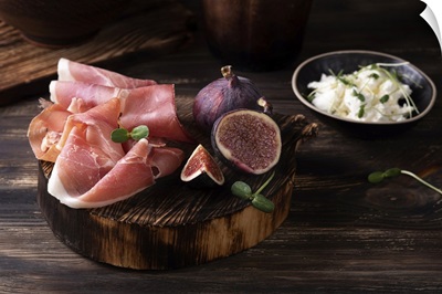 Prosciutto Slices With Figs On A Dark Wooden Background, Appetizer From Dry Cured Ham