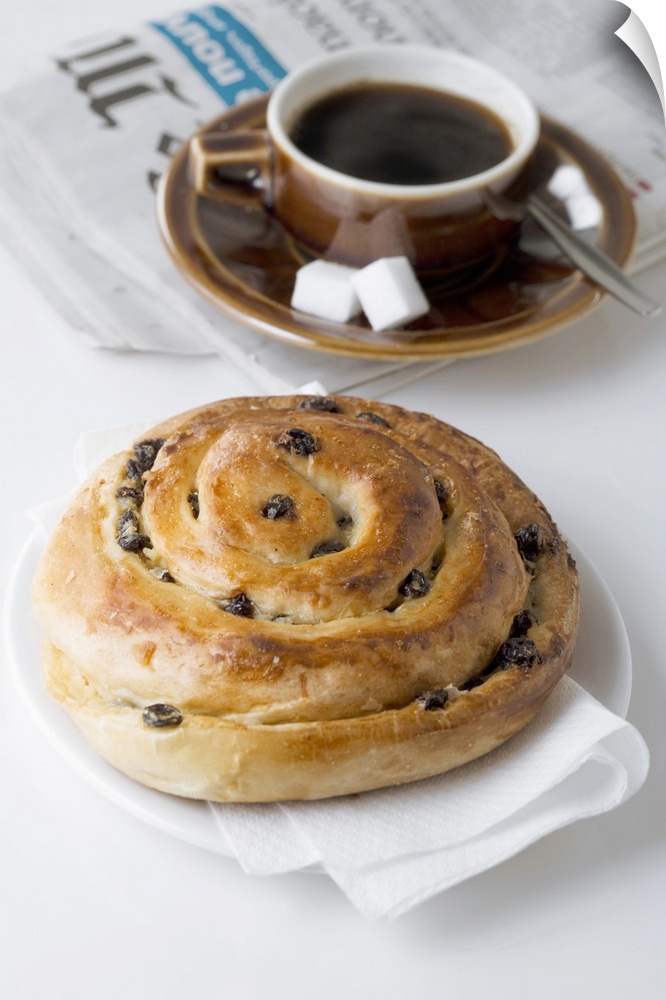 Raisin roll, coffee and newspaper on white background, close-up