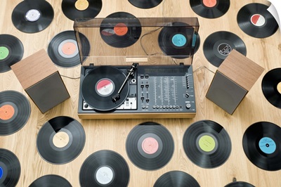 Records lying on floor surrounding 1970's stereo system