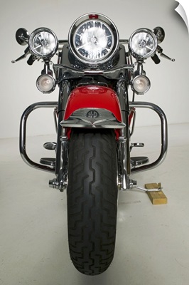 Red motorcycle parked in studio