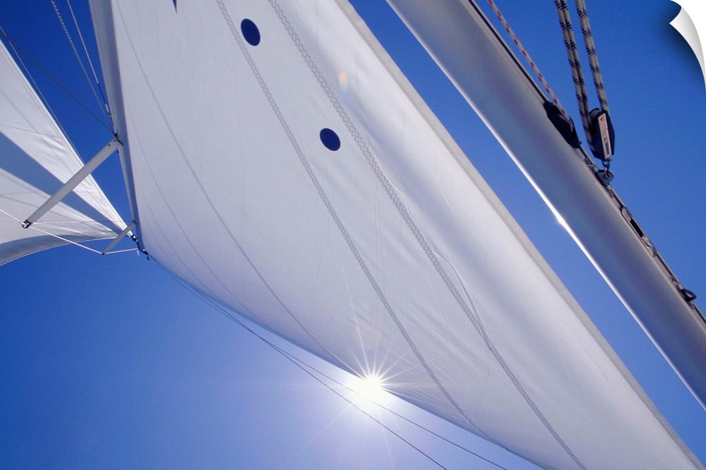 Sail on blue sky, close-up, low angle