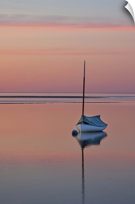 Sailboat and buoy at sunset.
