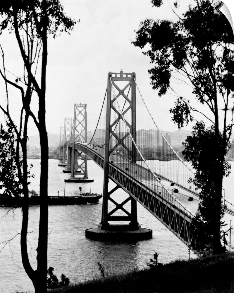 A ship crosses under the San Francisco Oakland Bay Bridge after its completion in 1936. The bridge, designed by Charles H....