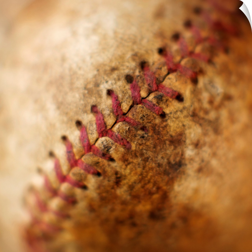 Big photograph emphasizes the stitching found on a worn ball made from cowhide that is used in the sport nicknamed "Americ...