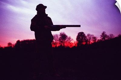 Silhouette of hunter with gun