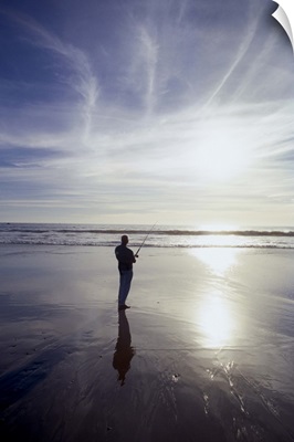 Silhouette of man fishing