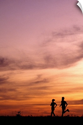 Silhouette of runners at sunset