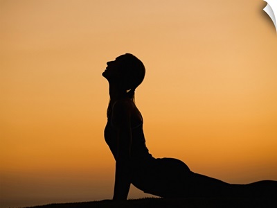 Silhouette of woman doing yoga