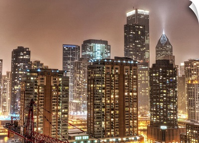 Snow falls over skyline at evening in Chicago.