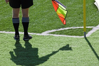 Soccer referee holding flag