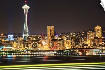 Space Needle with light trails from ferry in foreground at night, Seattle.