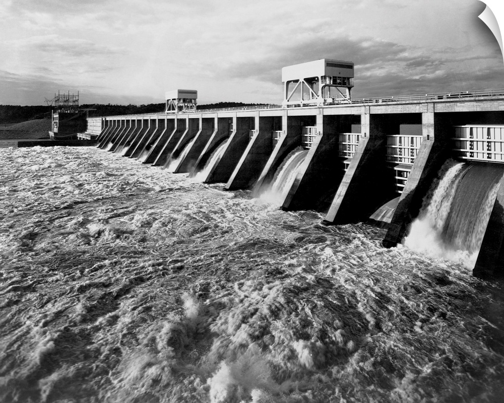 Water pours from open spillways at the Pickwick Landing Dam, a project of the Tennessee Valley Authority. Officials were c...