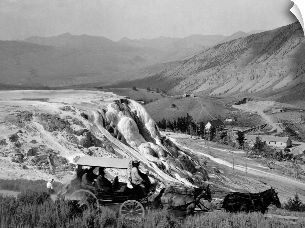 A stagecoach takes tourists past Jupiter Terrace in Mammoth Hot Springs, Yellowstone National Park. The buildings of Fort ...