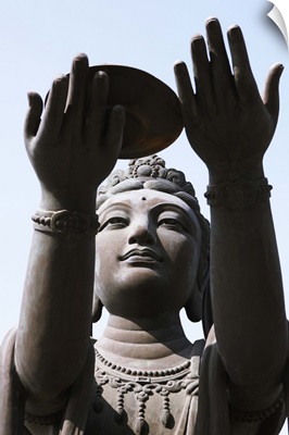 Statue of Buddha against blue sky