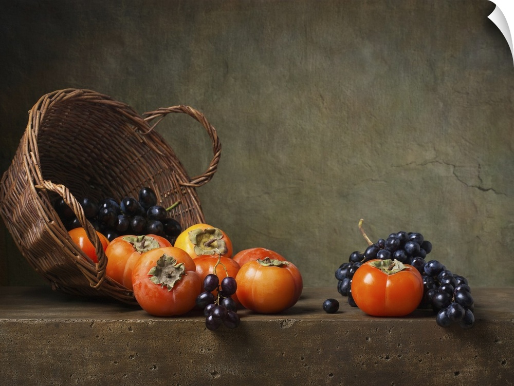 Still life with persimmons and grapes on the table.