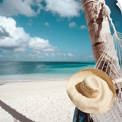 Straw Hat And Hammock At The Beach