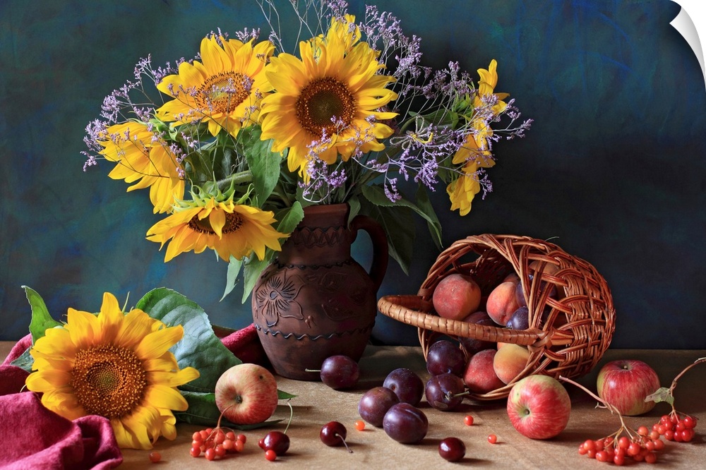 Big photograph composed of a flower arrangement sitting within and around a ceramic jug that is next to an assortment of f...