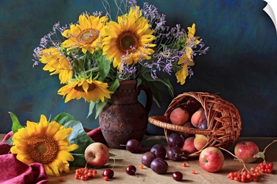 Summer still life with sunflowers, apples, peaches, plums, rowan berries and cherries