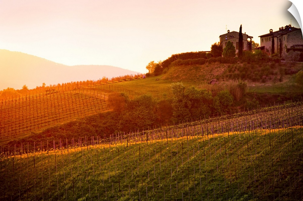 The setting sun shines its last rays over a picturesque villa and its fields in this photo of Tuscanny, Italy. Warm, relax...
