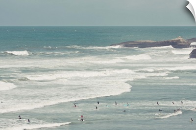 Surfers lying in ocean.